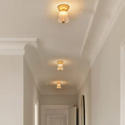 Nuura LED-Deckenlampe Asteea, Ø 12 cm, messingfarben/klar
